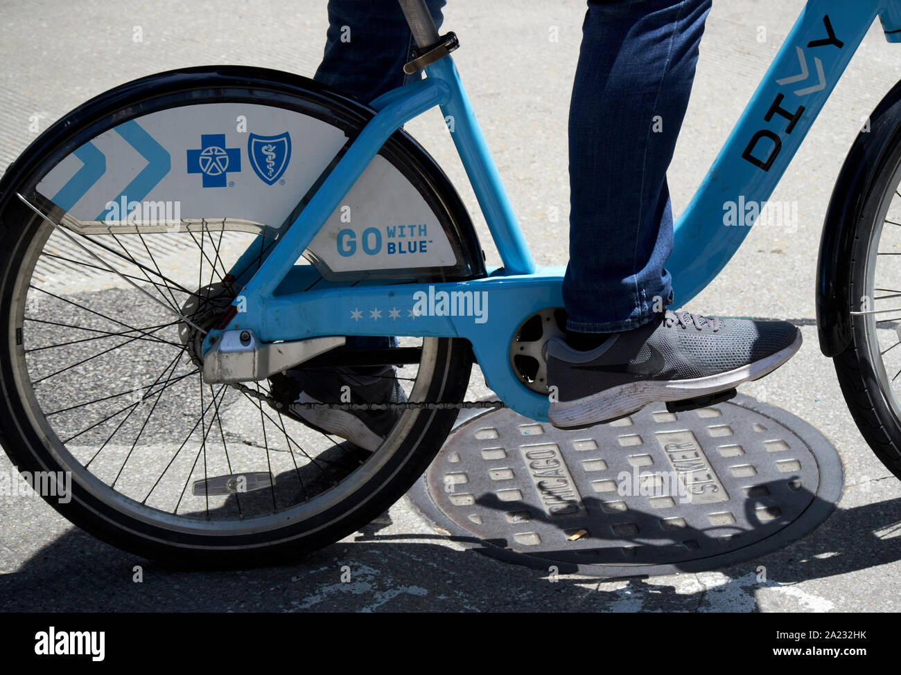 man riding blue chicago divvy rental bike in downtown chicago illinois united states of america Stock Photo