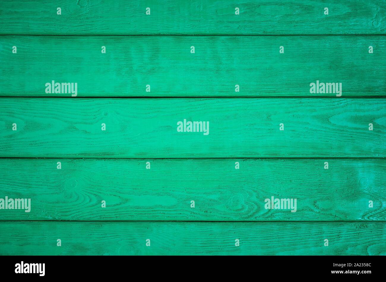 Wooden background texture. Creatively painted intense green boards. Stock Photo