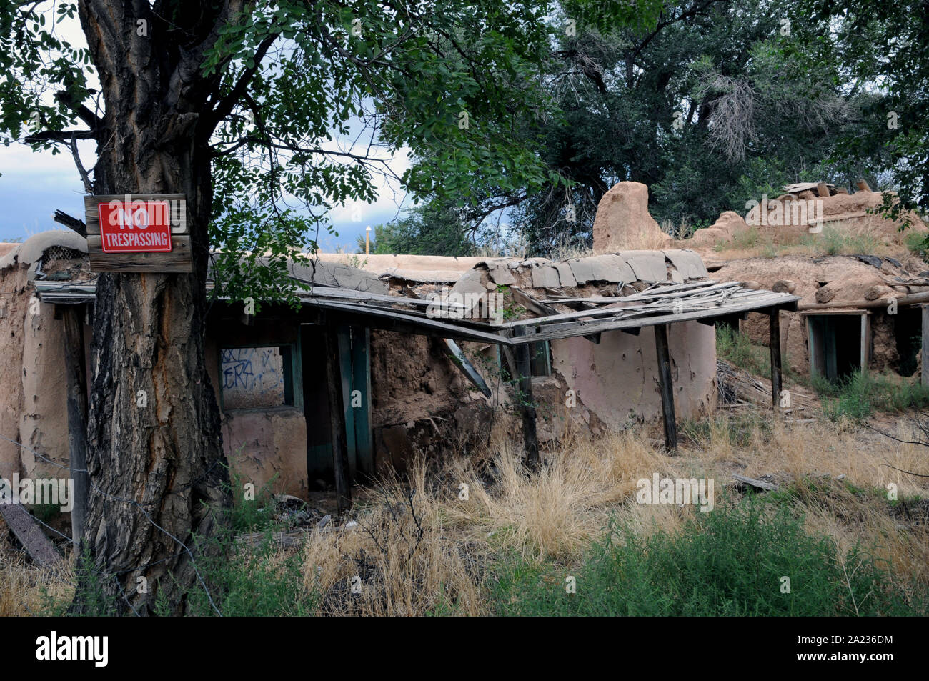 An abandoned and partly collapsed building in the Plaza area of Ranchos de Taos in New Mexico. In its day it had been both a residence and shop. Stock Photo