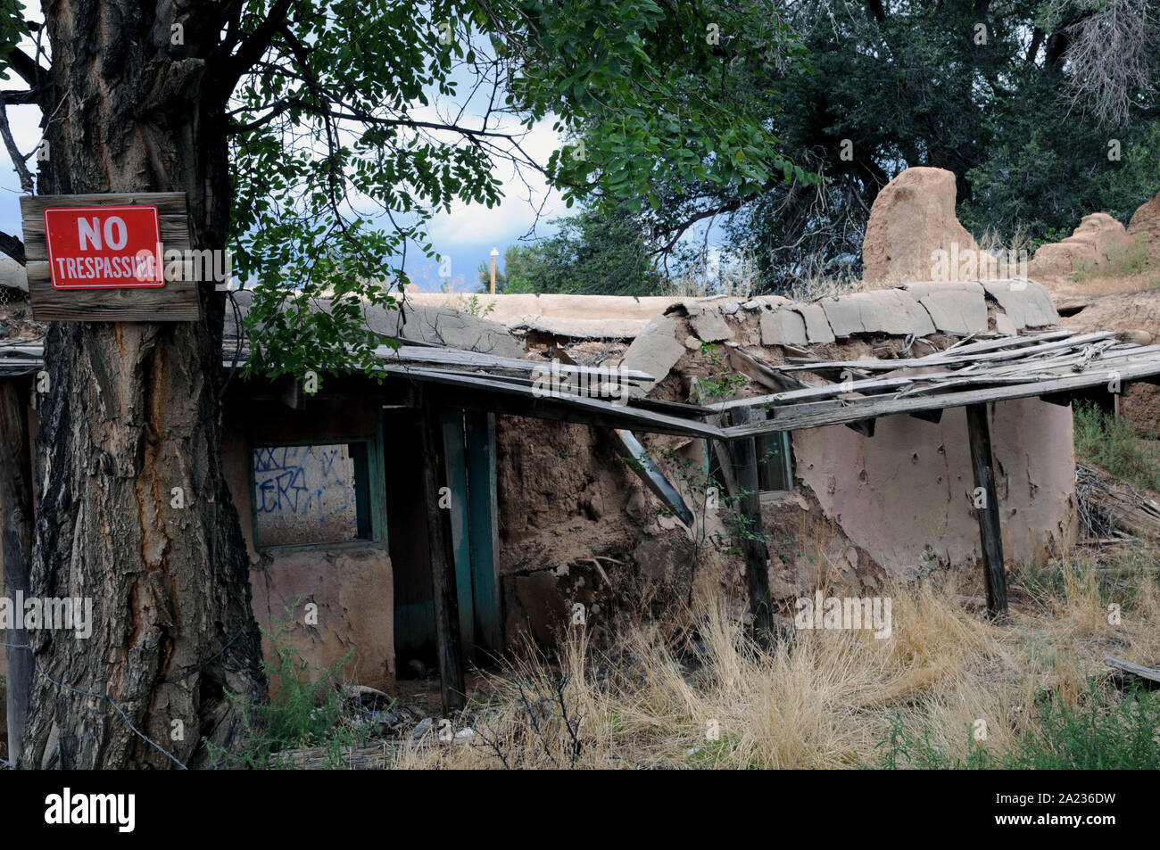 An abandoned and partly collapsed building in the Plaza area of Ranchos de Taos in New Mexico. In its day it had been both a residence and shop. Stock Photo