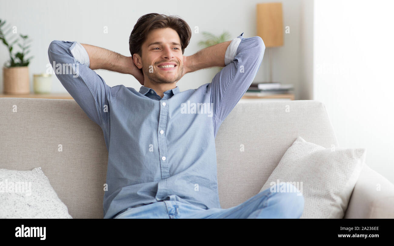 Happy Guy Relaxing Sitting On Couch Having Lazy Day Off When