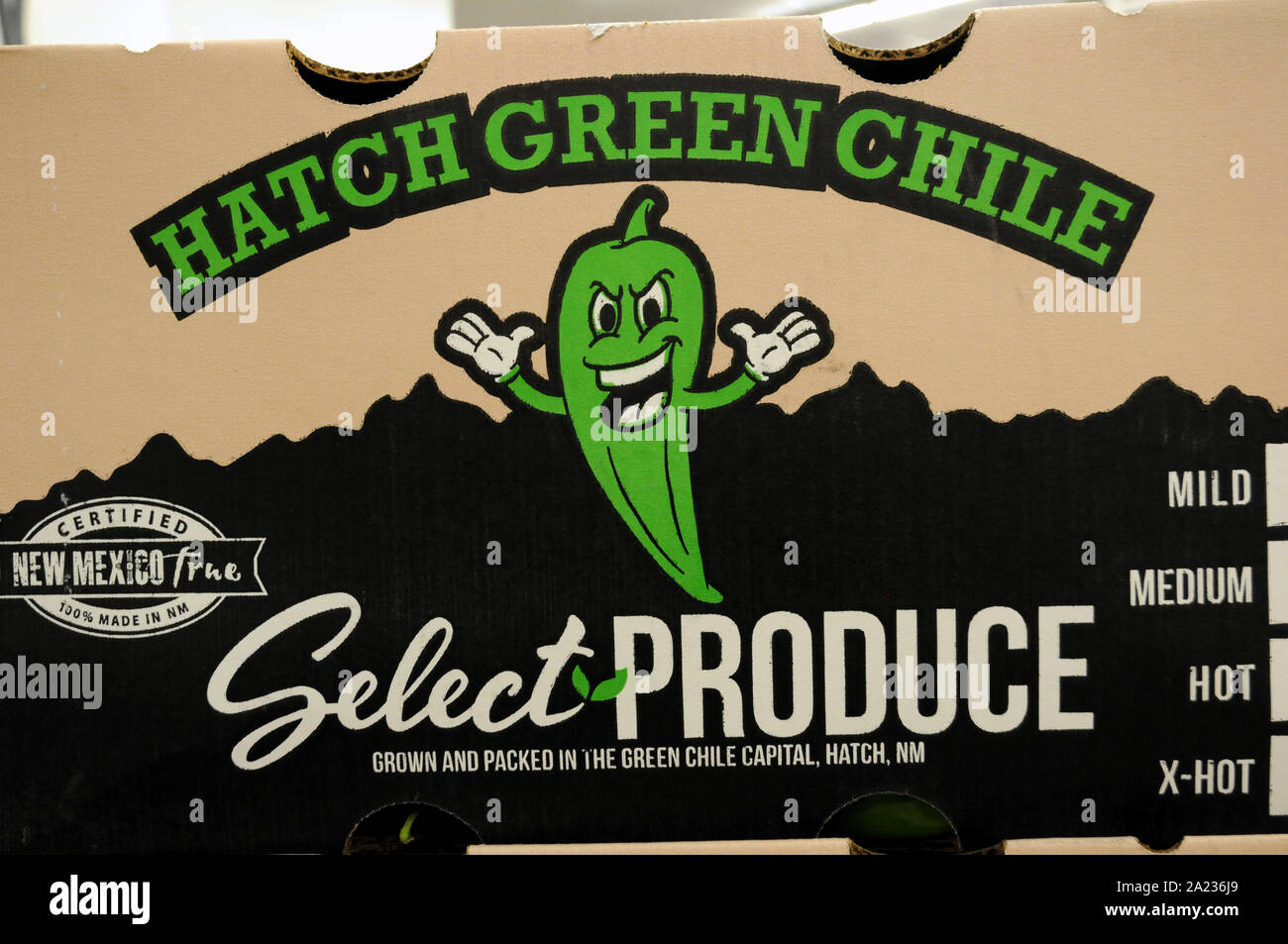 Large boxes of Hatch chilies on sale in a supermarket in Taos, New Mexico. once bought they are taken outside the shop to be roasted. Stock Photo