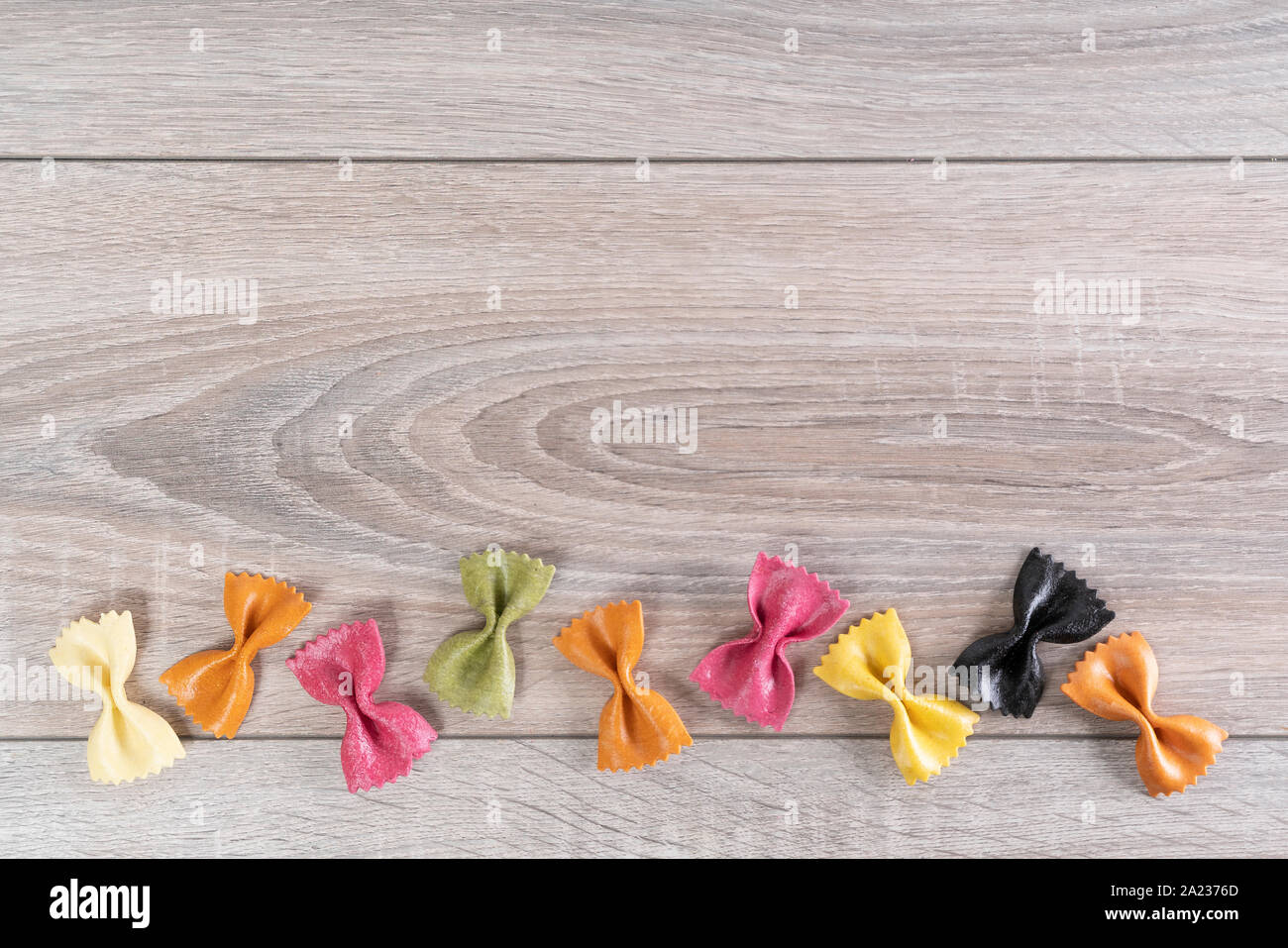 Italian pasta colored with natural dyes on the wooden table Stock Photo ...