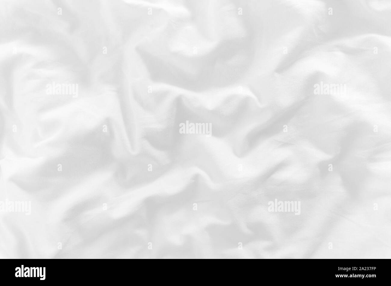 white crumpled bed sheet closeup top view Stock Photo