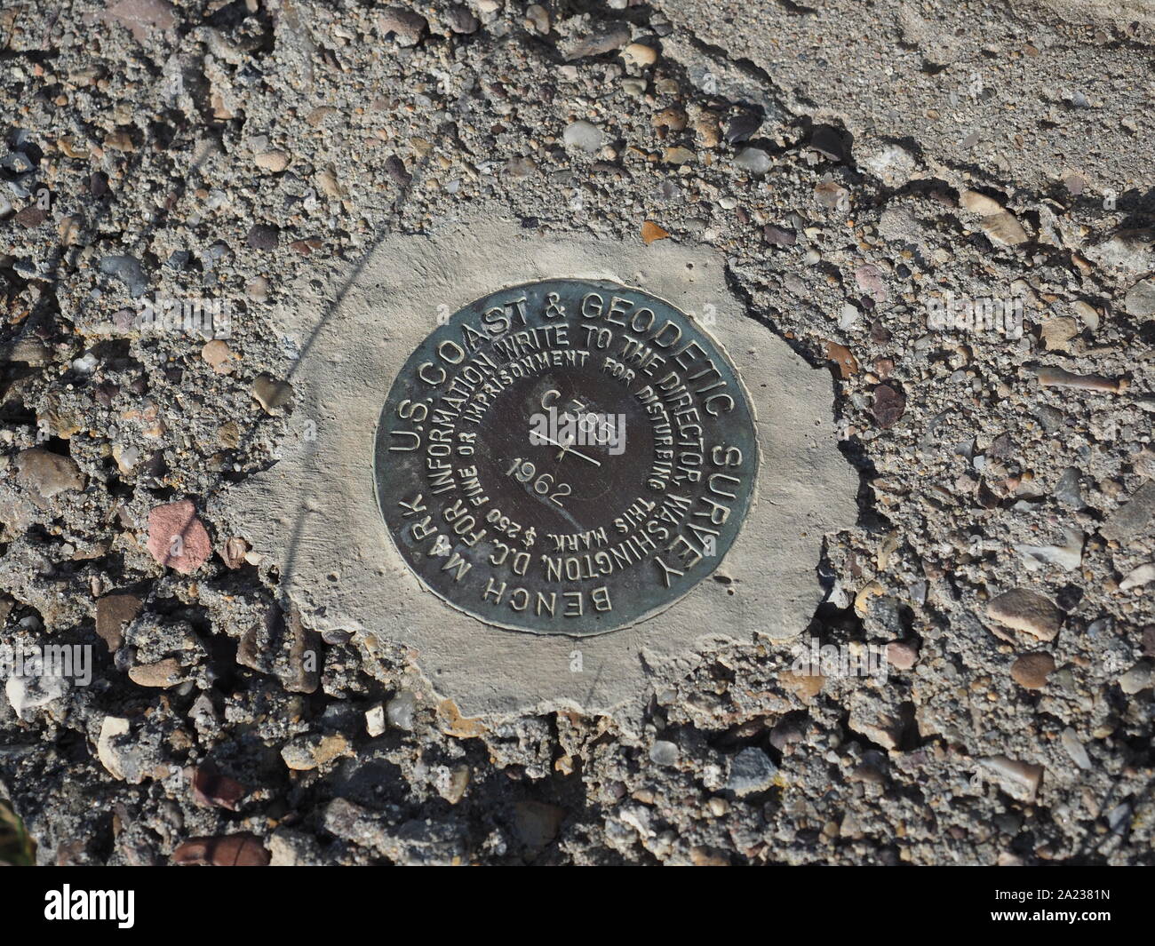 United States Coast and Geodetic Survey marker embedded in the ground Stock Photo