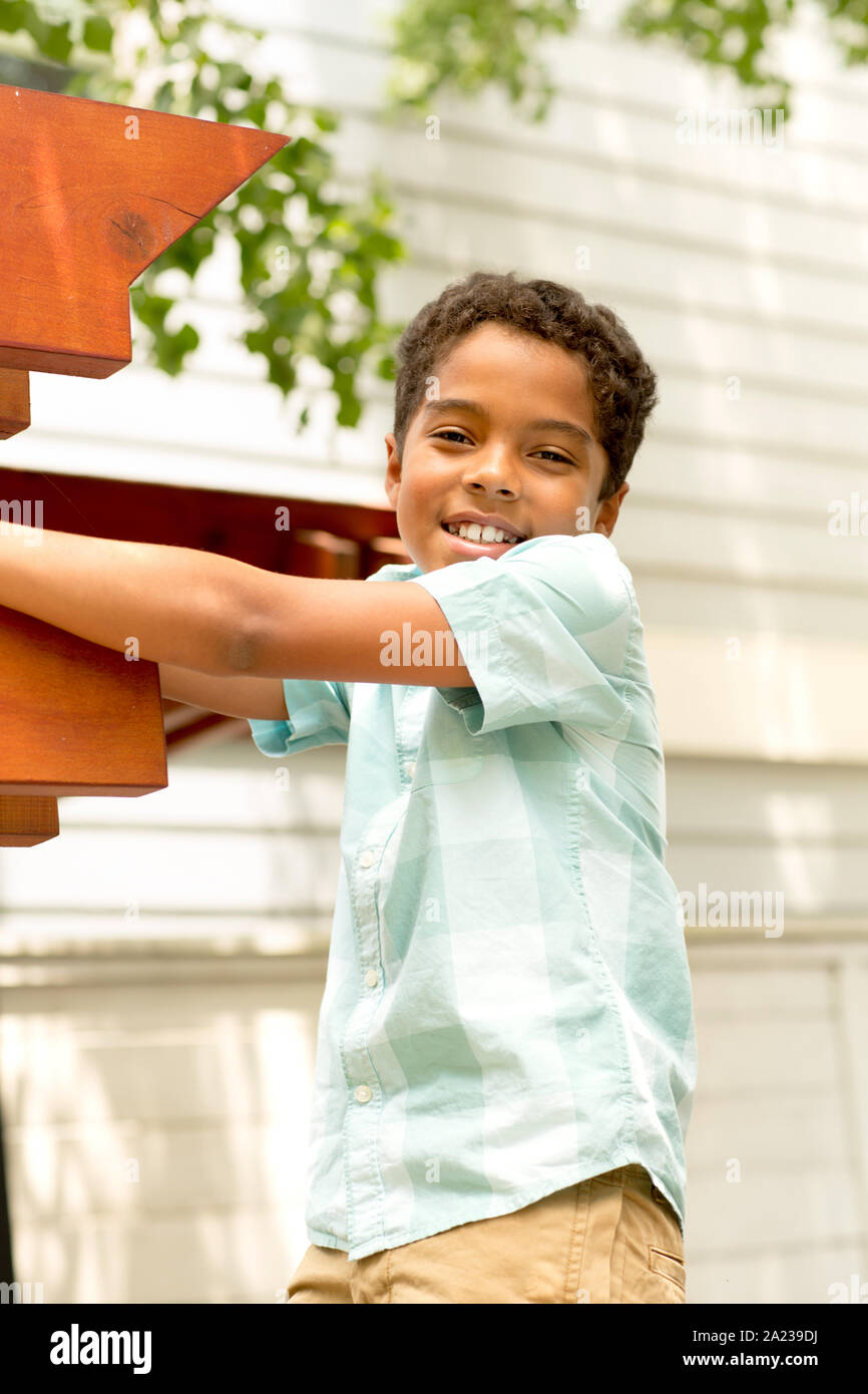 Young mixed race little boy playing and smiling. Stock Photo