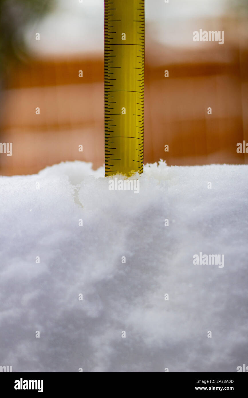 Measuring the snow depth with ruler not numbers Stock Photo