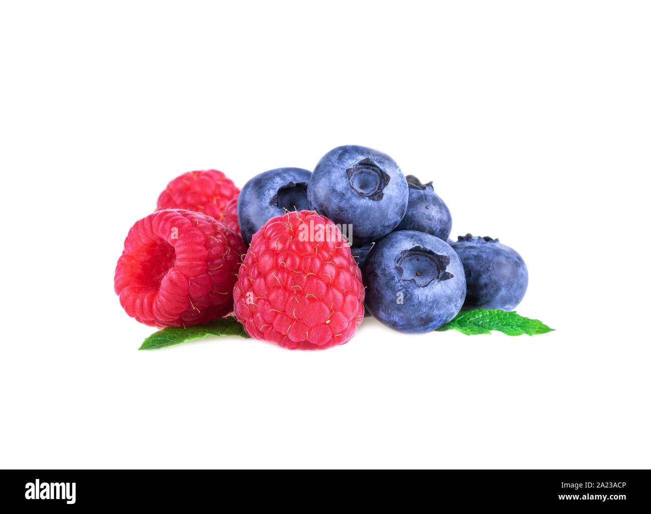 Raspberries with blueberries and mint leaves isolated on white background Stock Photo