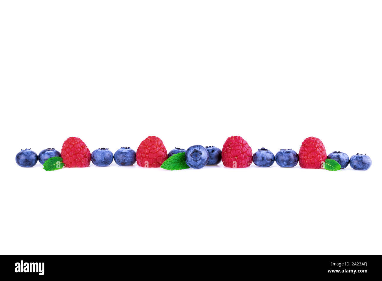 Raspberries and Blueberries in a line isolated on white. Fresh berry mix concept. Stock Photo