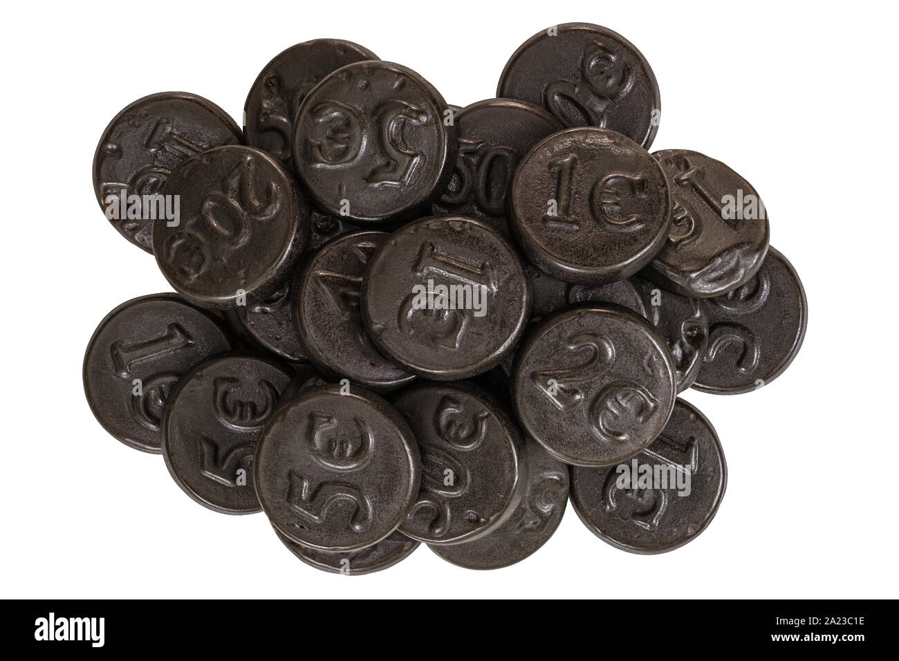 A pile of black salty liquorice coins on a white background Stock Photo