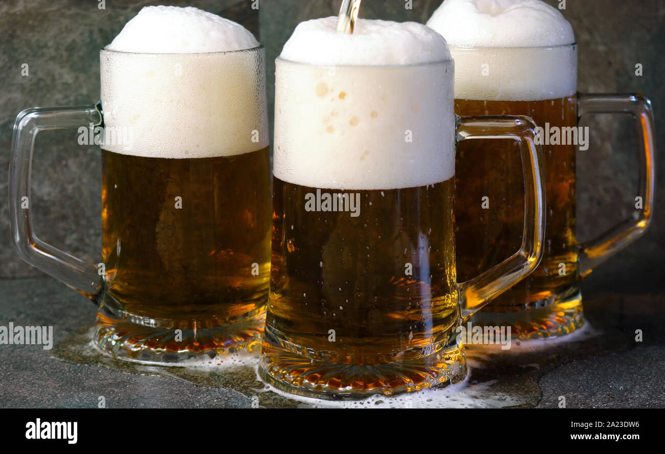 Pouring Beer Into Traditional Beer Steins On Black Slate Bar Table Stock Photo Alamy Pouring Beer Into Traditional Beer Steins On Black Slate Bar Table Stock Photo Alamy