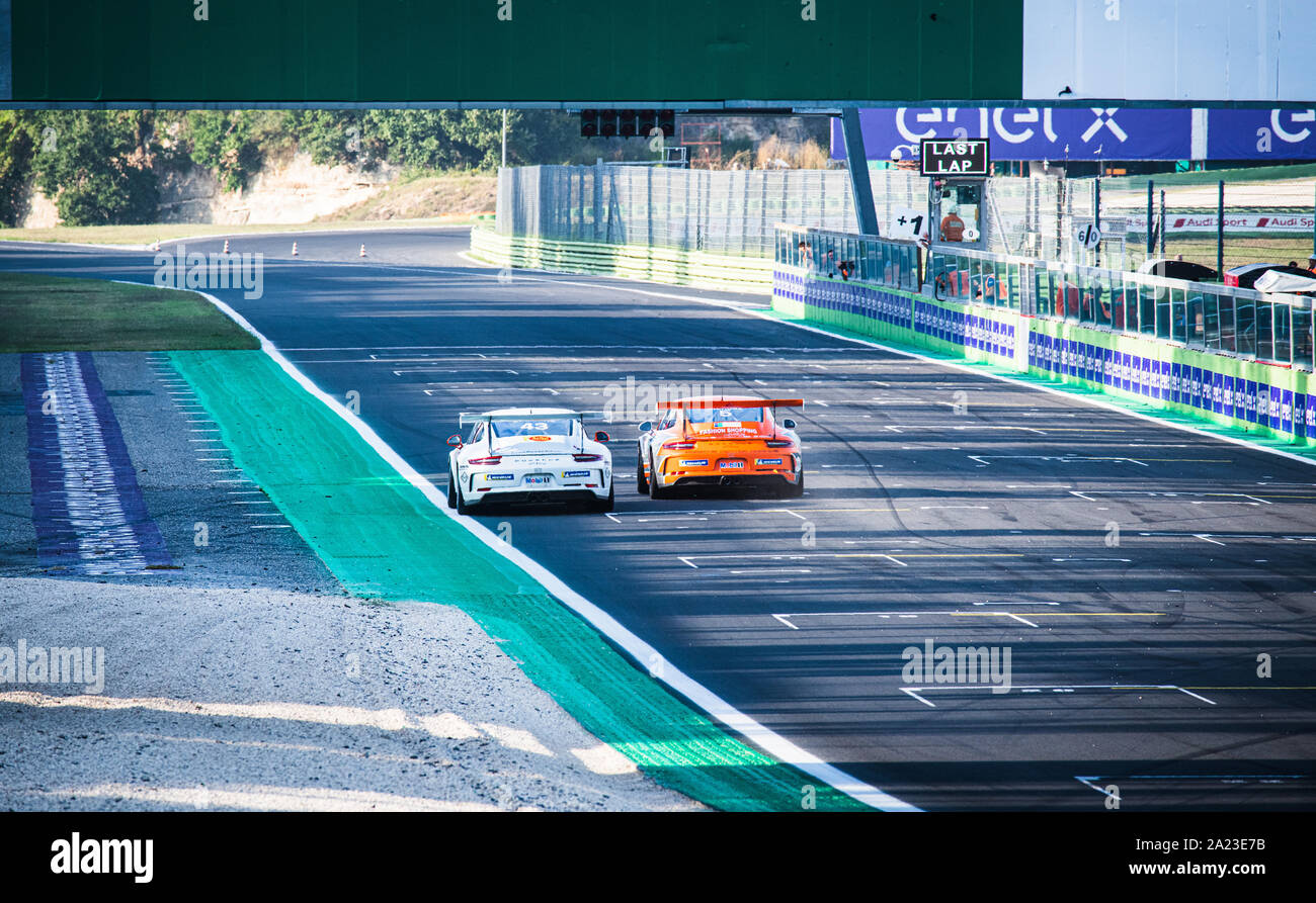 Vallelunga, Italy september 14 2019. Rear view of two Porsche Carrera racing car battle overtaking on finish line Stock Photo