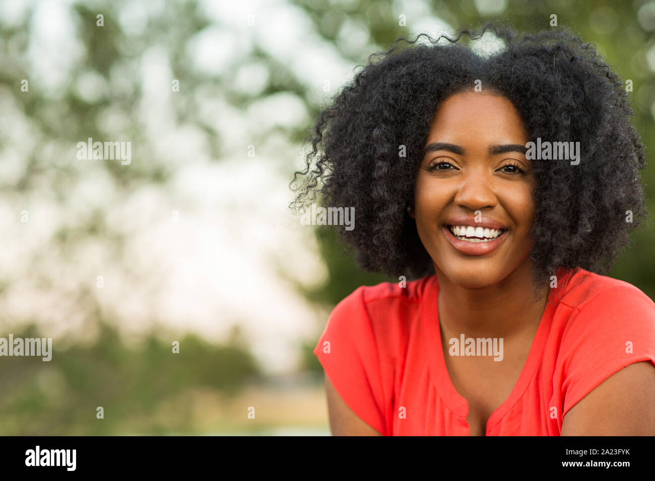 Happy confident African American woman smiling outside. Stock Photo