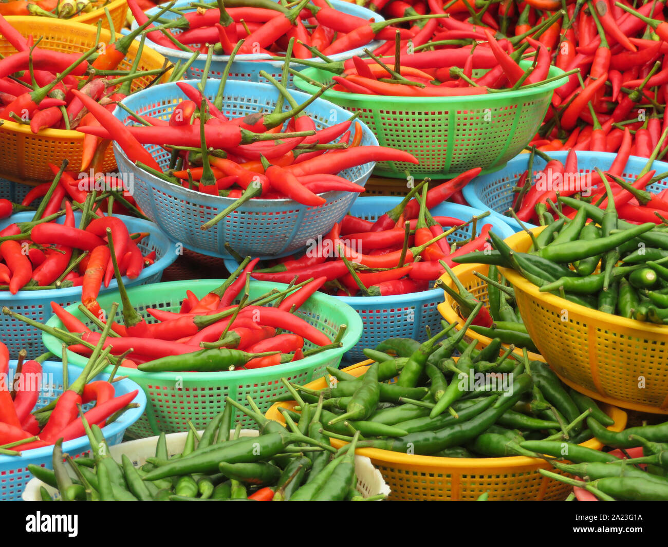 Red and green chili peppers in baskets. Hot spices at the street market
