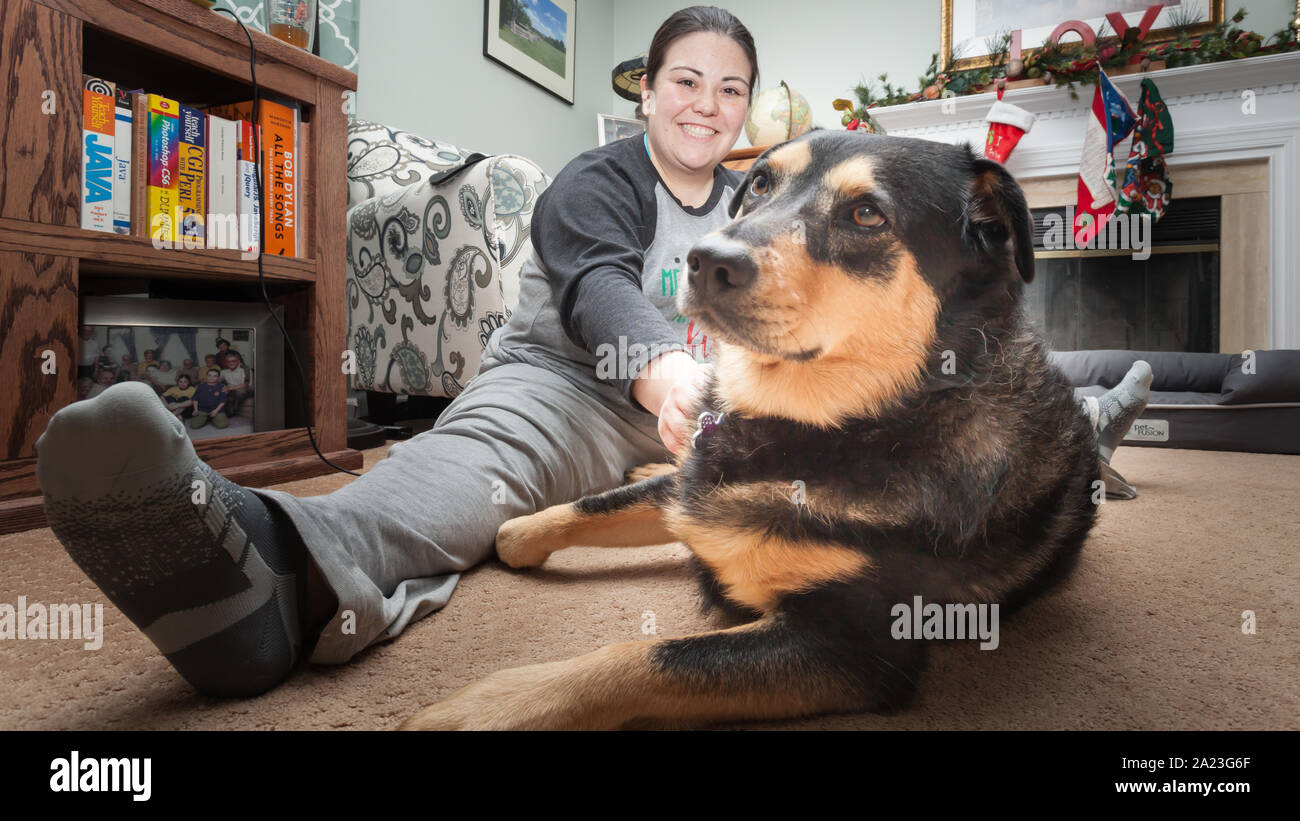 Young rescue dog playing with new family members. Stock Photo