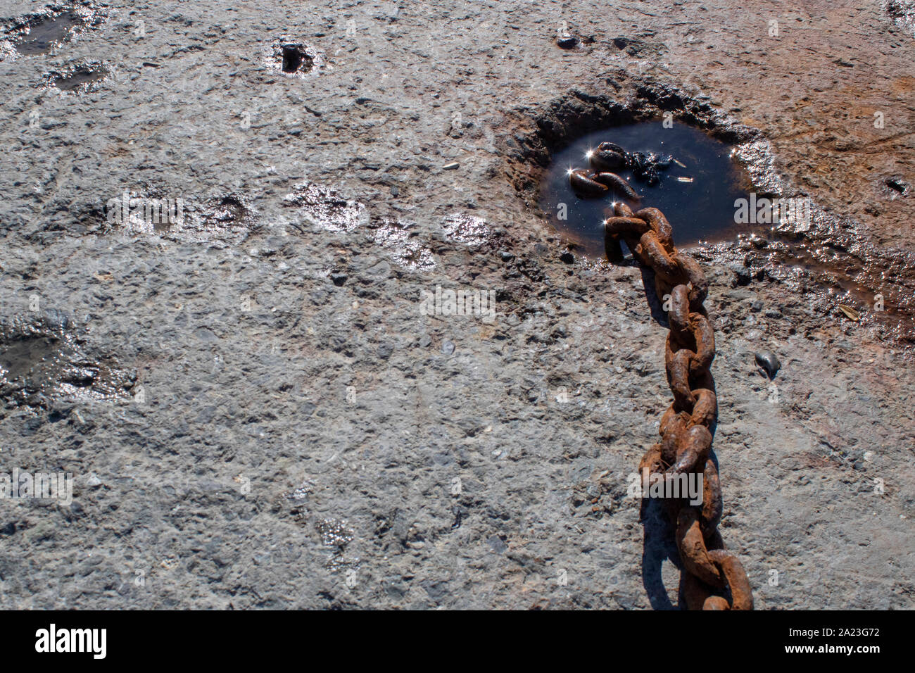 Chain anchors buried in concrete to moor in port Stock Photo Alamy