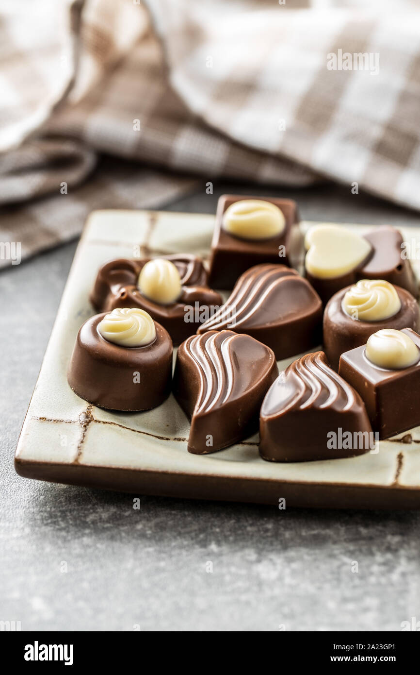Various chocolate pralines on plate. Stock Photo