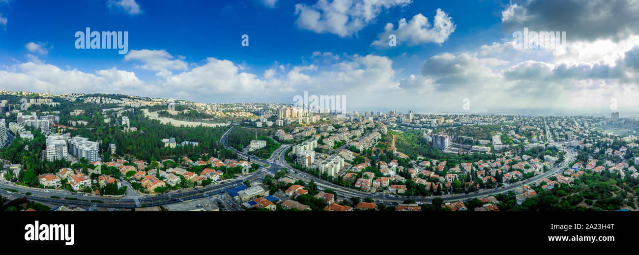 Aerial panorama of Ramot Remez and Romema modern neighborhoods with major intersecting roads modern houses with white walls and red roofs, high rising Stock Photo