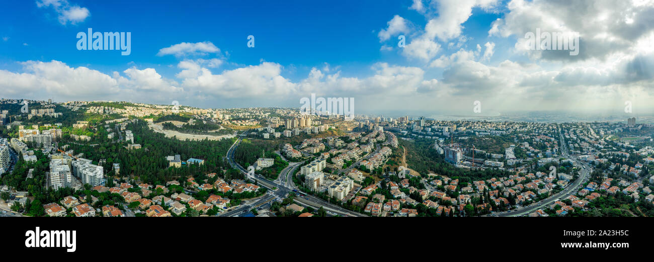 Aerial panorama of Ramot Remez and Romema modern neighborhoods with major intersecting roads modern houses with white walls and red roofs, high rising Stock Photo