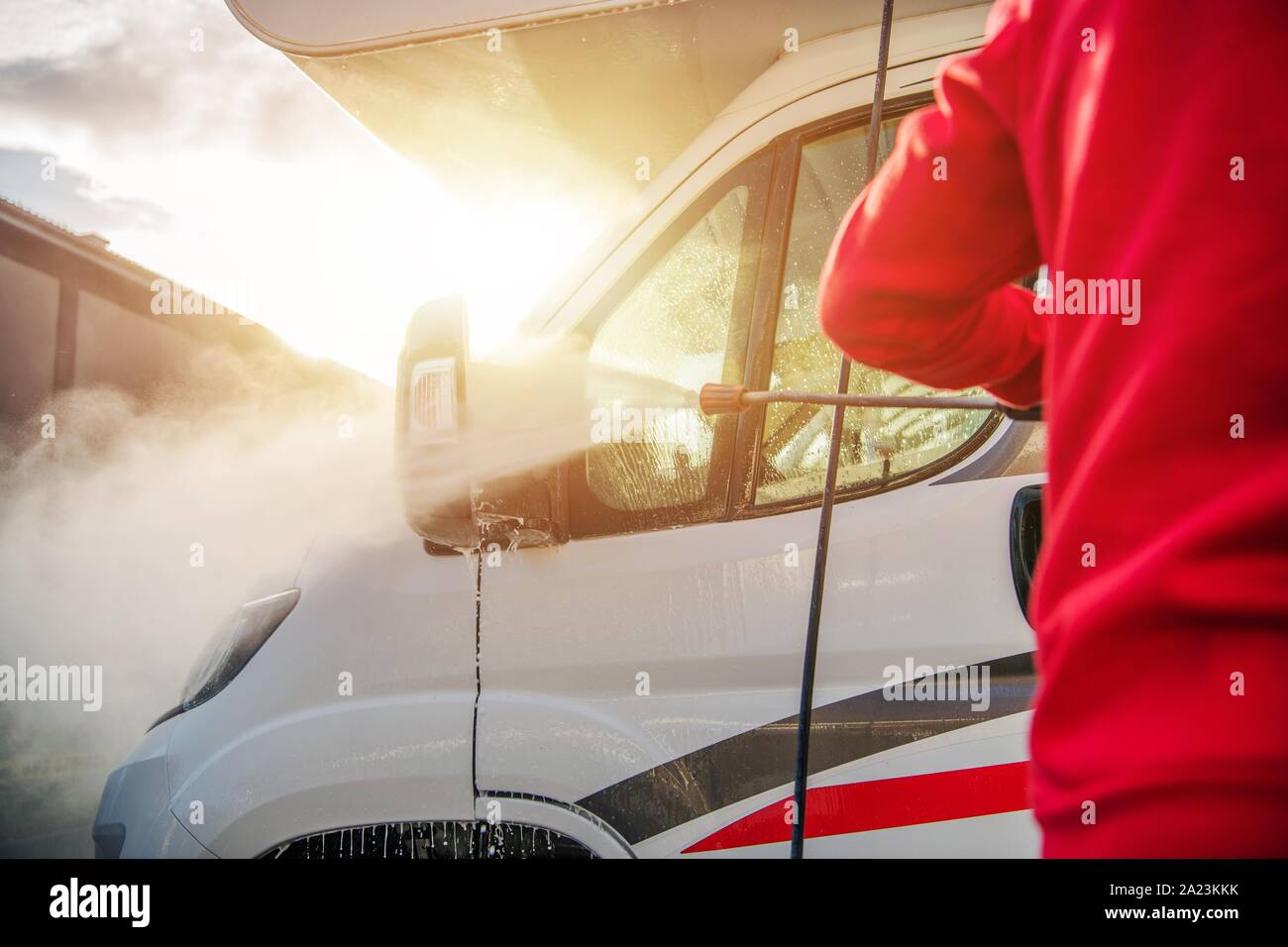 Caucasian Men Washing Camper Van RV Using Pressure Washer. After Season