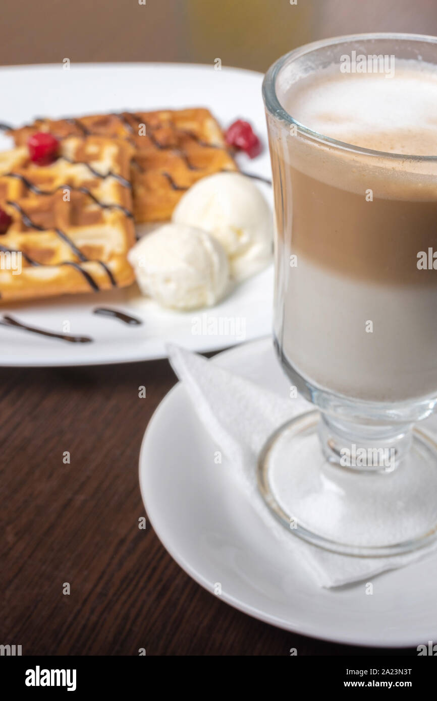 Viennese waffles with latte coffee, on a wooden table. Stock Photo