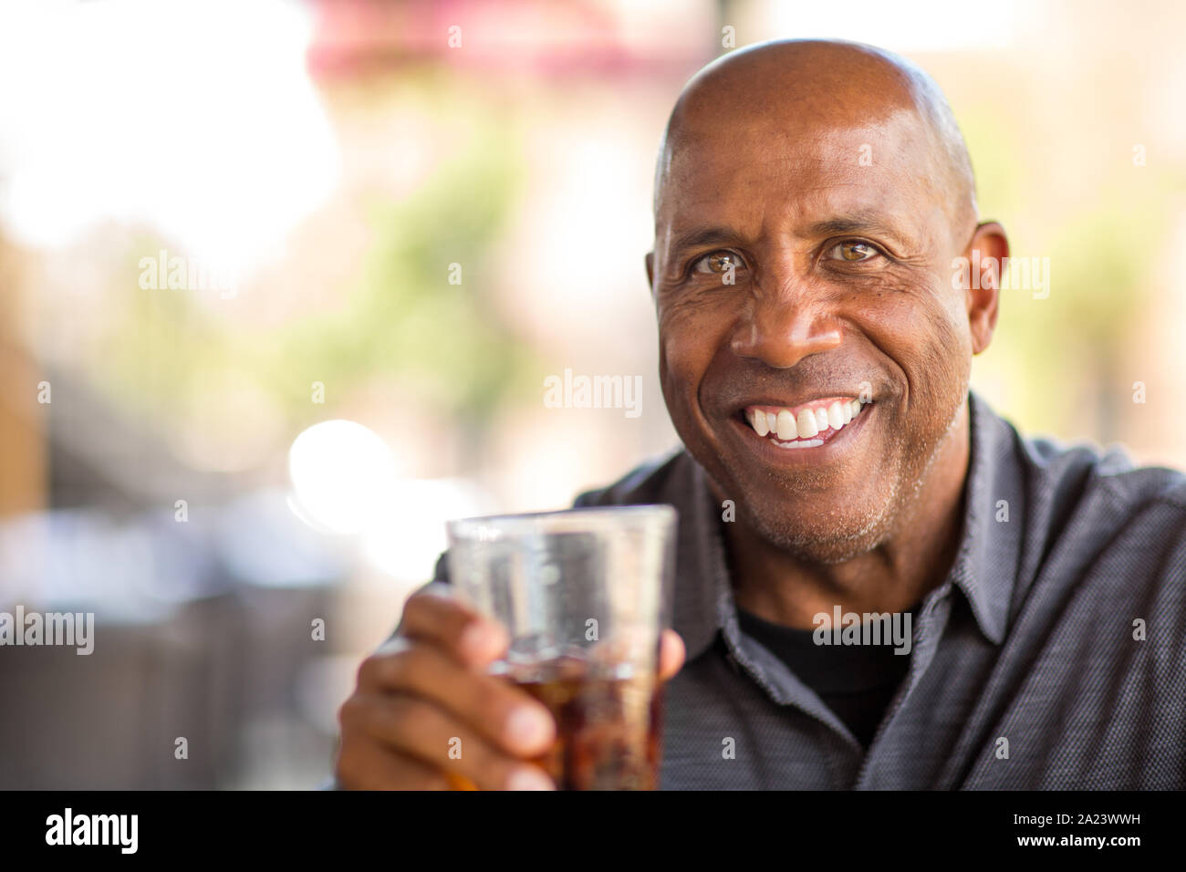 Mature African American man drinking at a restaurant Stock Photo - Alamy
