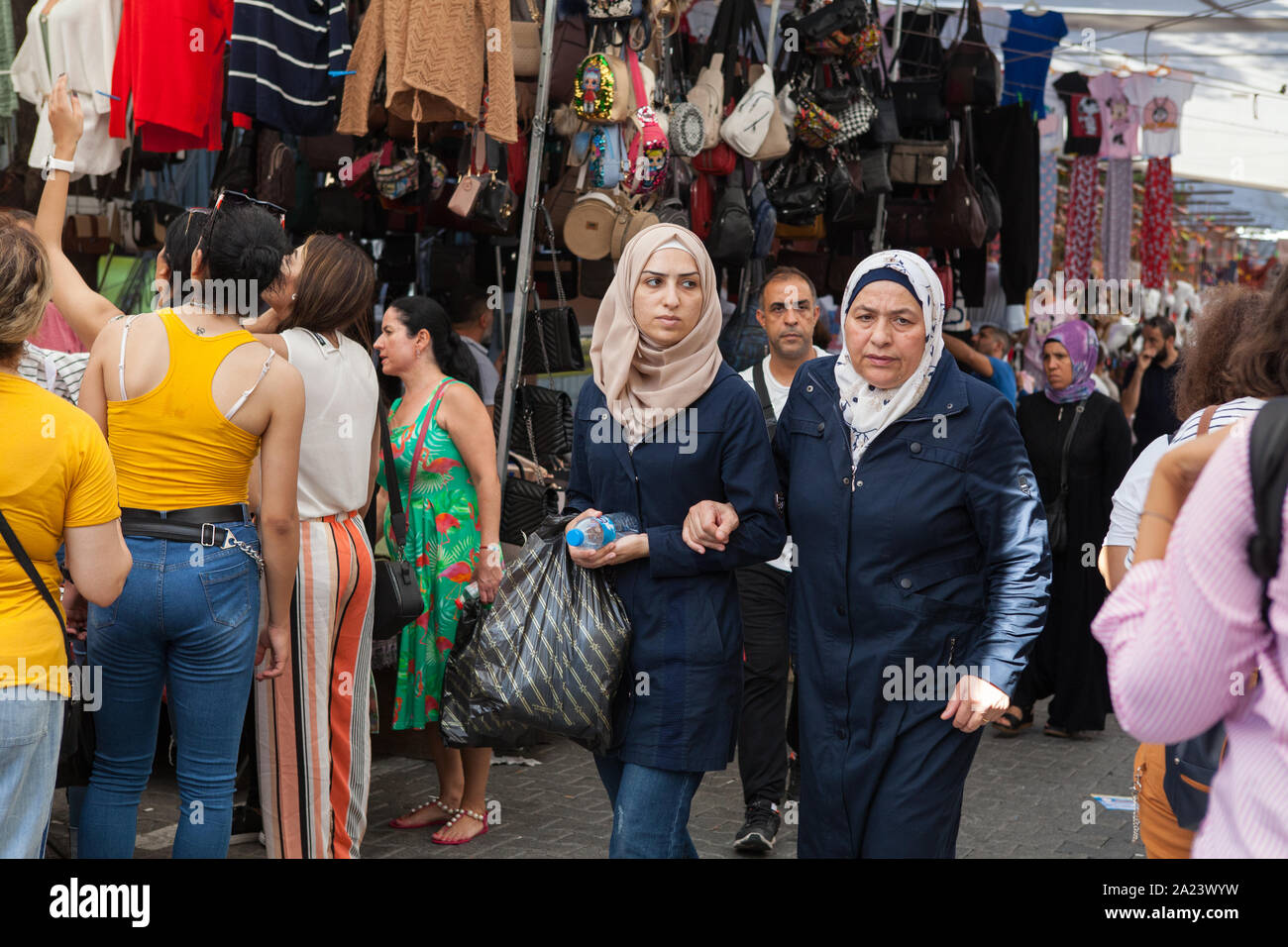 A muslim mother and daughter walk through the market in the Fatih district of Istanbul Stock Photo
