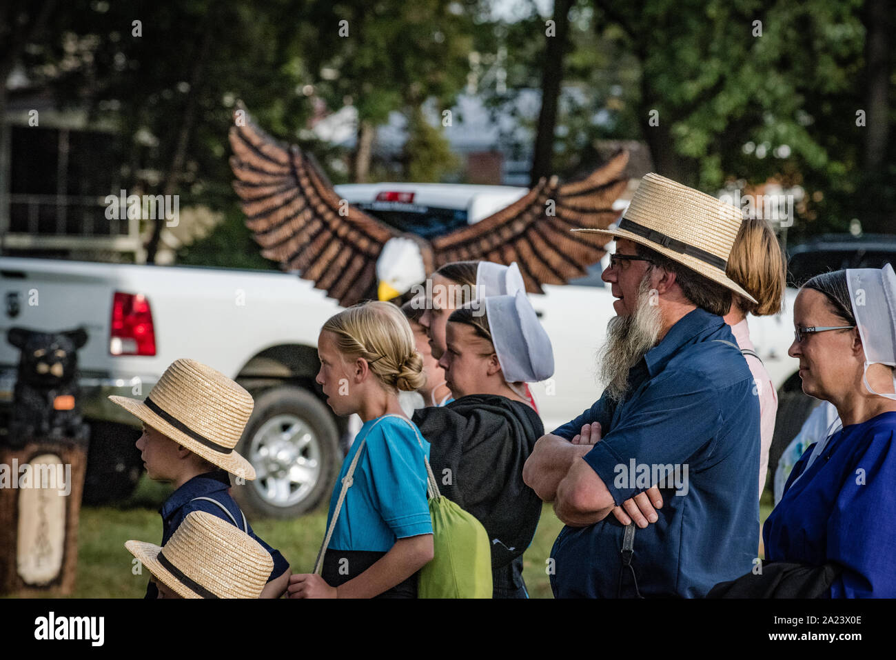 Amish family at country fair, auction Stock Photo Alamy