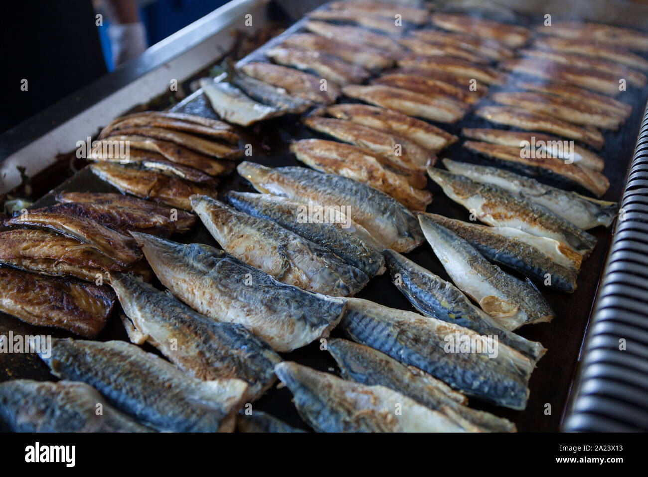 Fillets of mackerel are grilled in a fish restaurant beneath the Galata