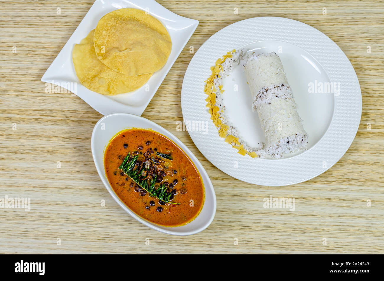 Traditional Kerala breakfast dish - Puttu with black chickpeas curry & pappad Stock Photo