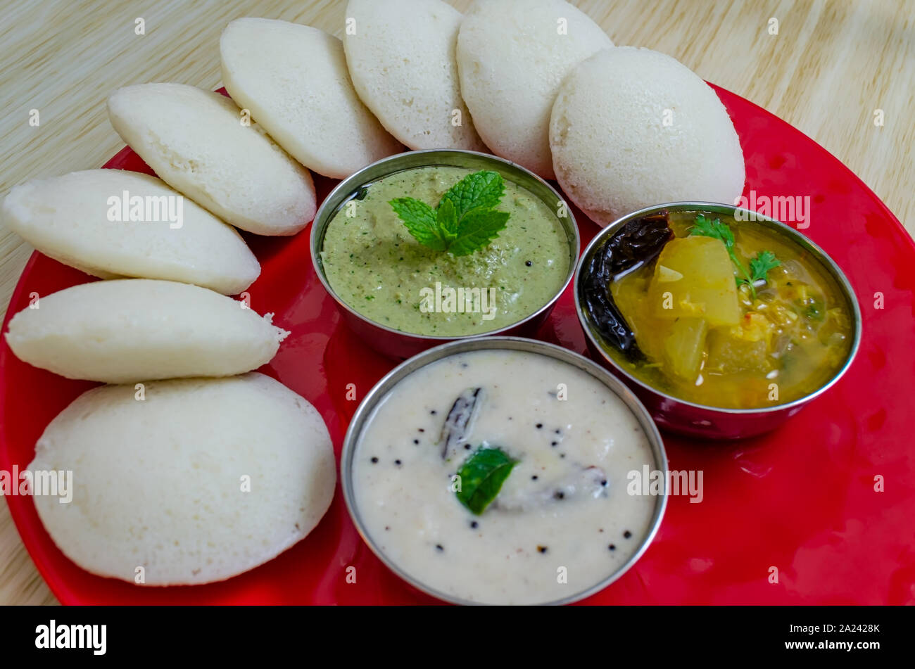 Beautifully arranged Idli, Sambar and chutneys. Macro Shot Stock Photo
