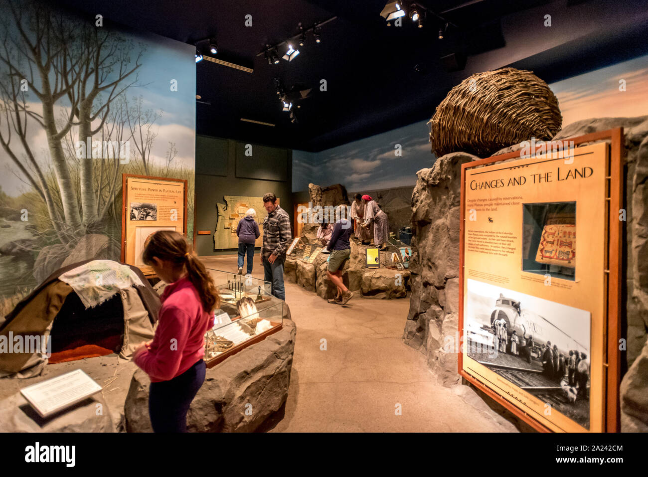 Visitors to the High Desert Museum in Bend, Oregon, explore the exhibits teaching about the lives of Plateau area Native Americans. Stock Photo