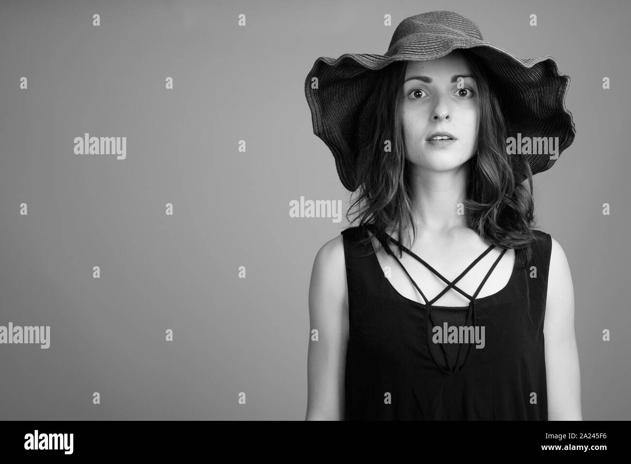 Studio shot of young beautiful woman in black and white Stock Photo