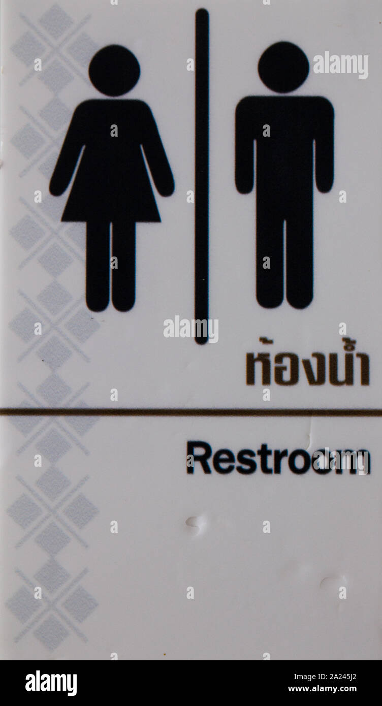 restroom sign in English language and thai Stock Photo Alamy