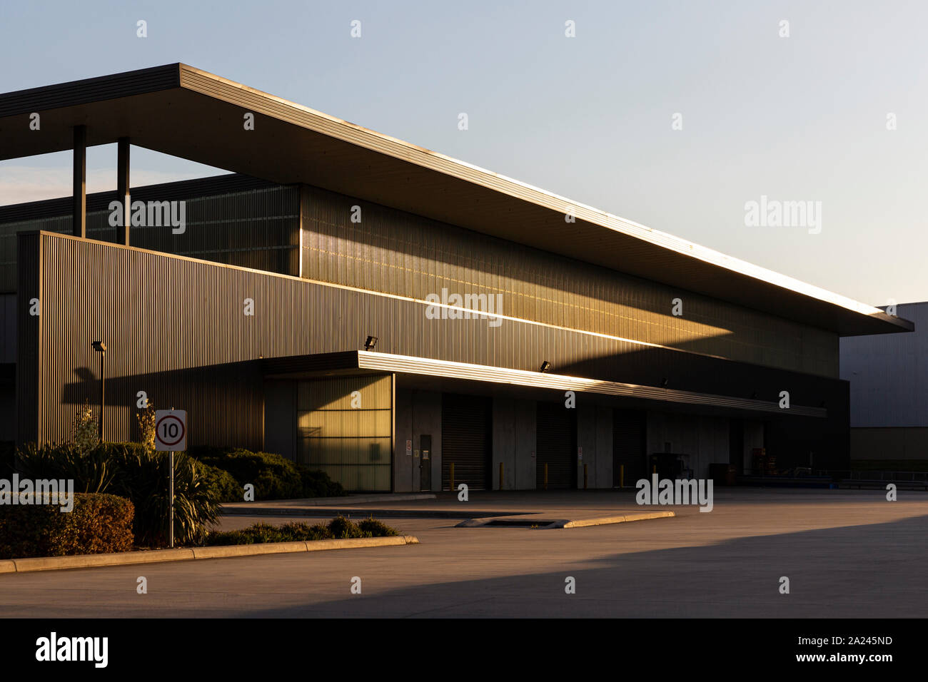 Modern warehouse exterior during afternoon dusk sunlight Stock Photo