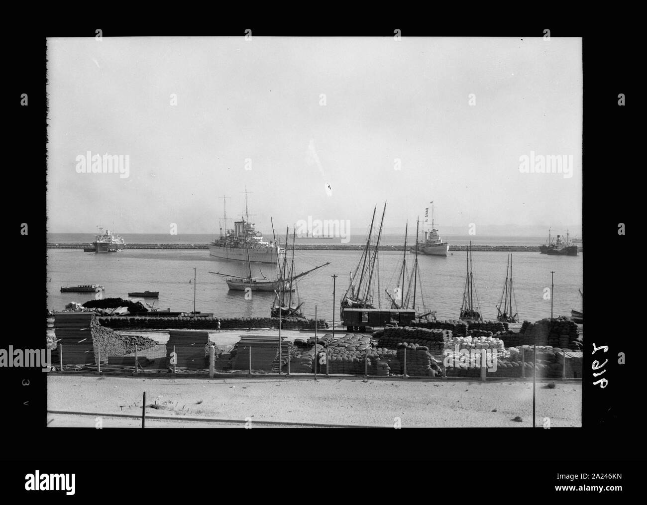 Palestine disturbances 1936. Haifa harbour, The S.S. Laurentic which carried the troops, is seen in the distance, cruisers in harbour Stock Photo