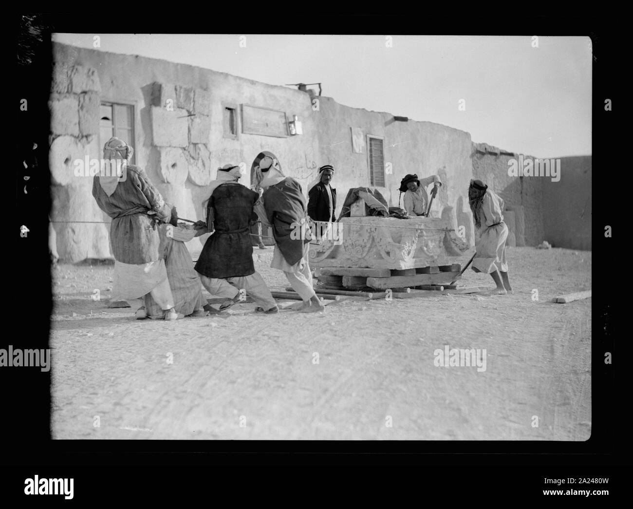Palmyra. Workmen moving massive capital Stock Photo