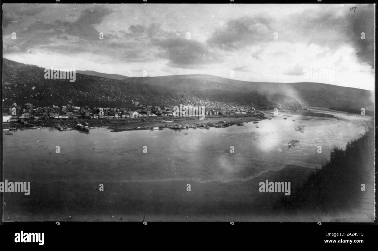Panorama of Dawson, North West Territories; Bird's-eye view with Yukon River in foreground; city and mountains in background.; Stock Photo