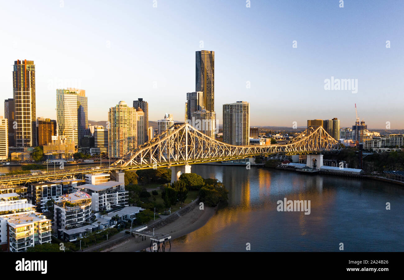Aerial view of Brisbane CBD and story bridge at sunrise above the river. Stock Photo