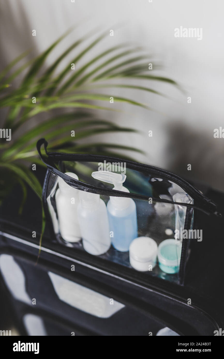 packing for a flight and airport screening concept, transparent bag with small lotions for