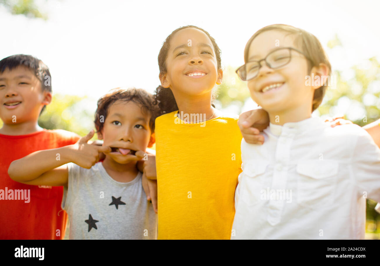 Multi-ethnic group of school kids laughing and embracing Stock Photo ...