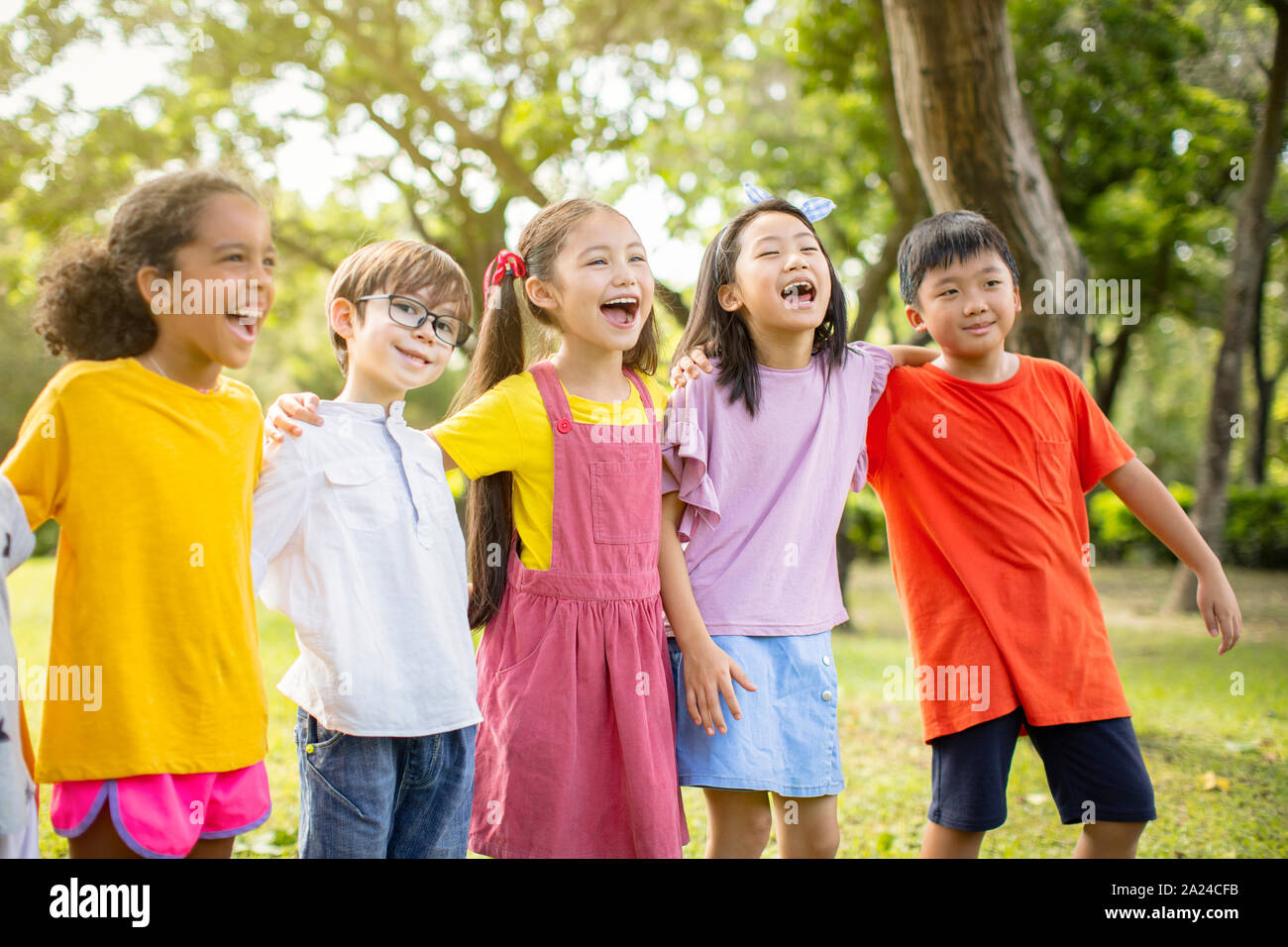 Multi-ethnic group of school kids laughing and embracing Stock Photo ...