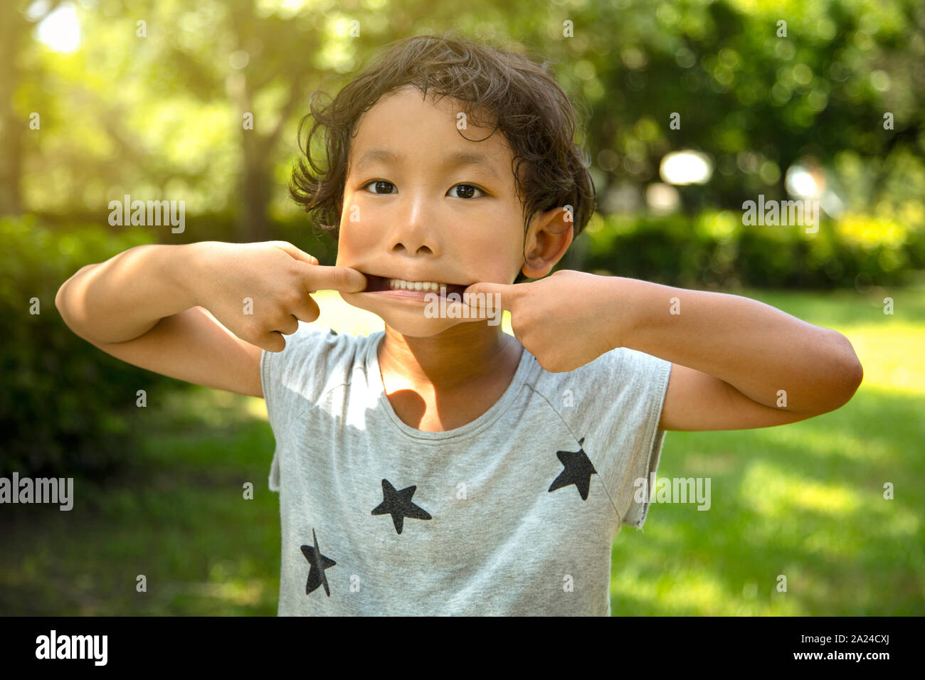 little boy making a funny face Stock Photo