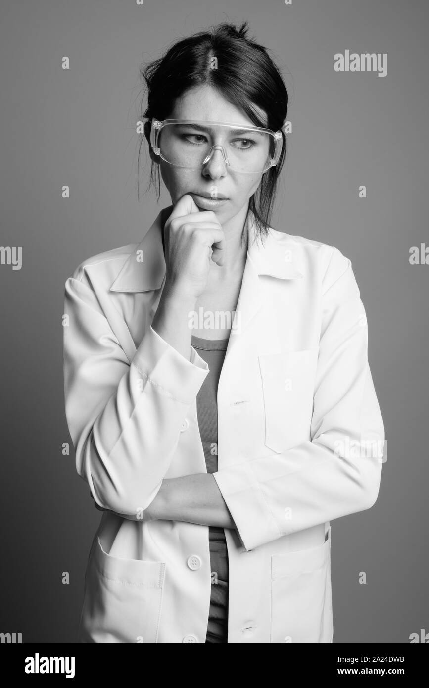 Scientist doctor wearing protective glasses shot in black and white Stock Photo