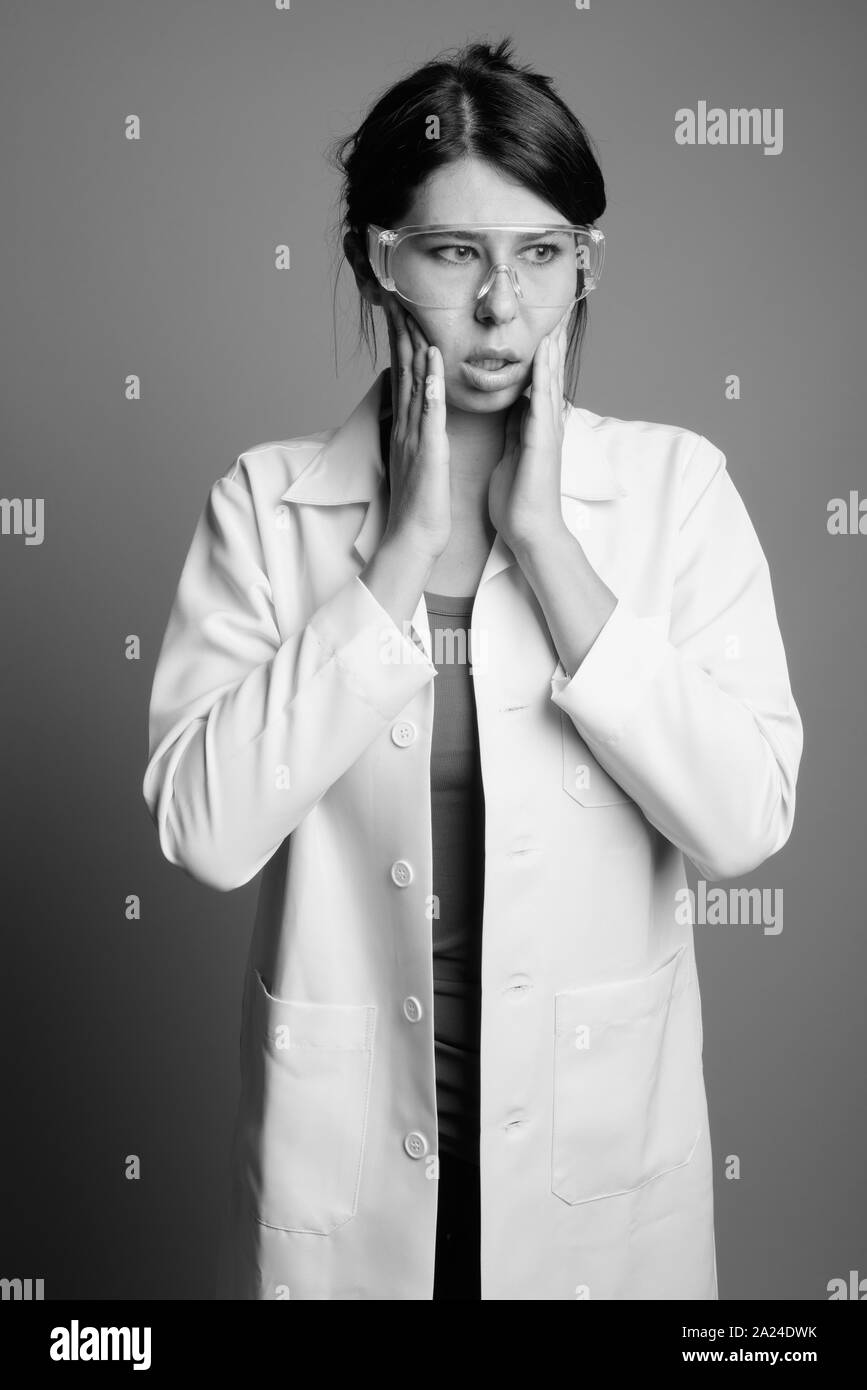 Scientist doctor wearing protective glasses shot in black and white Stock Photo