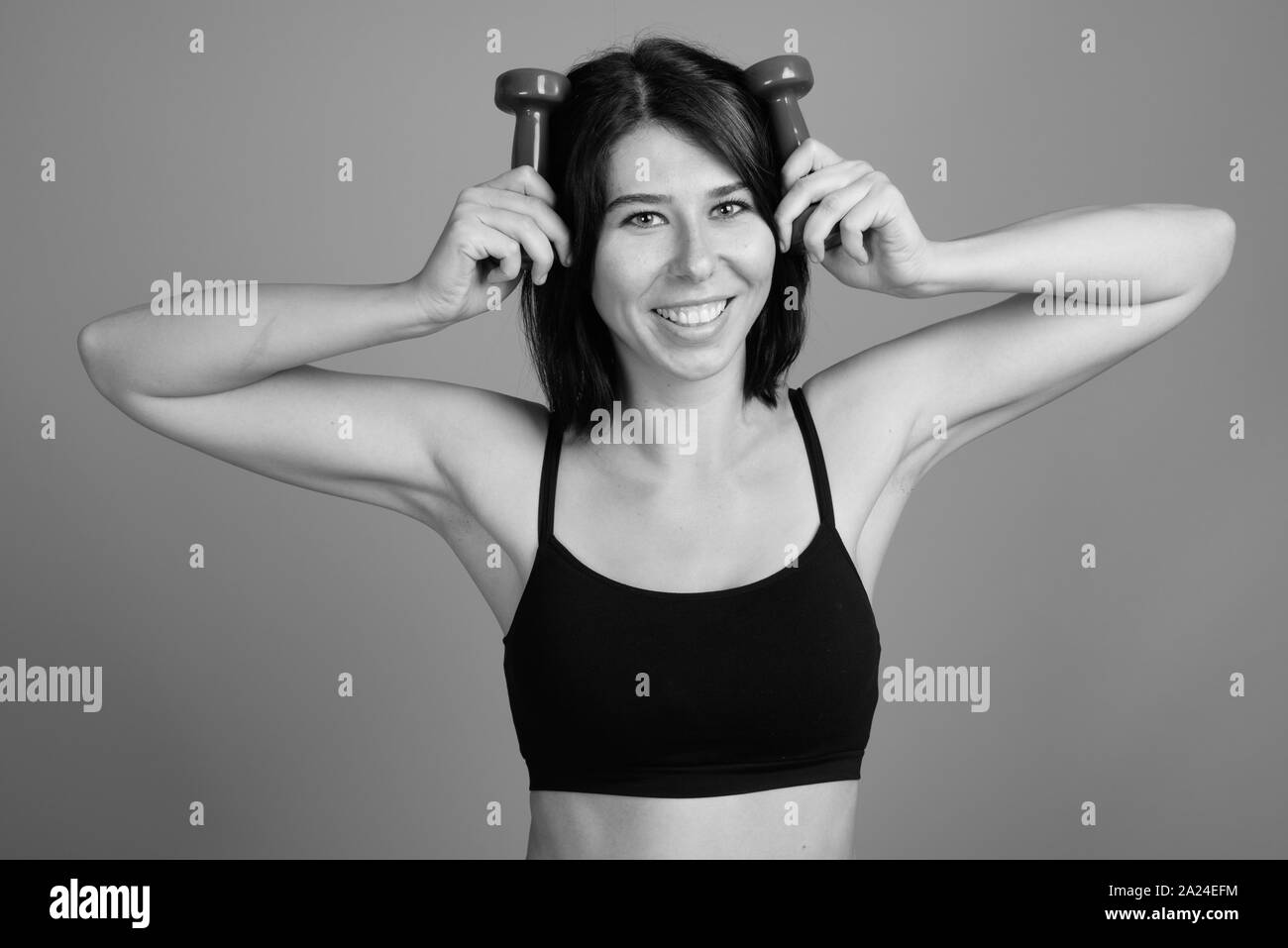 Shaping and fitness equipment. Dumbbells made of pink plastic near