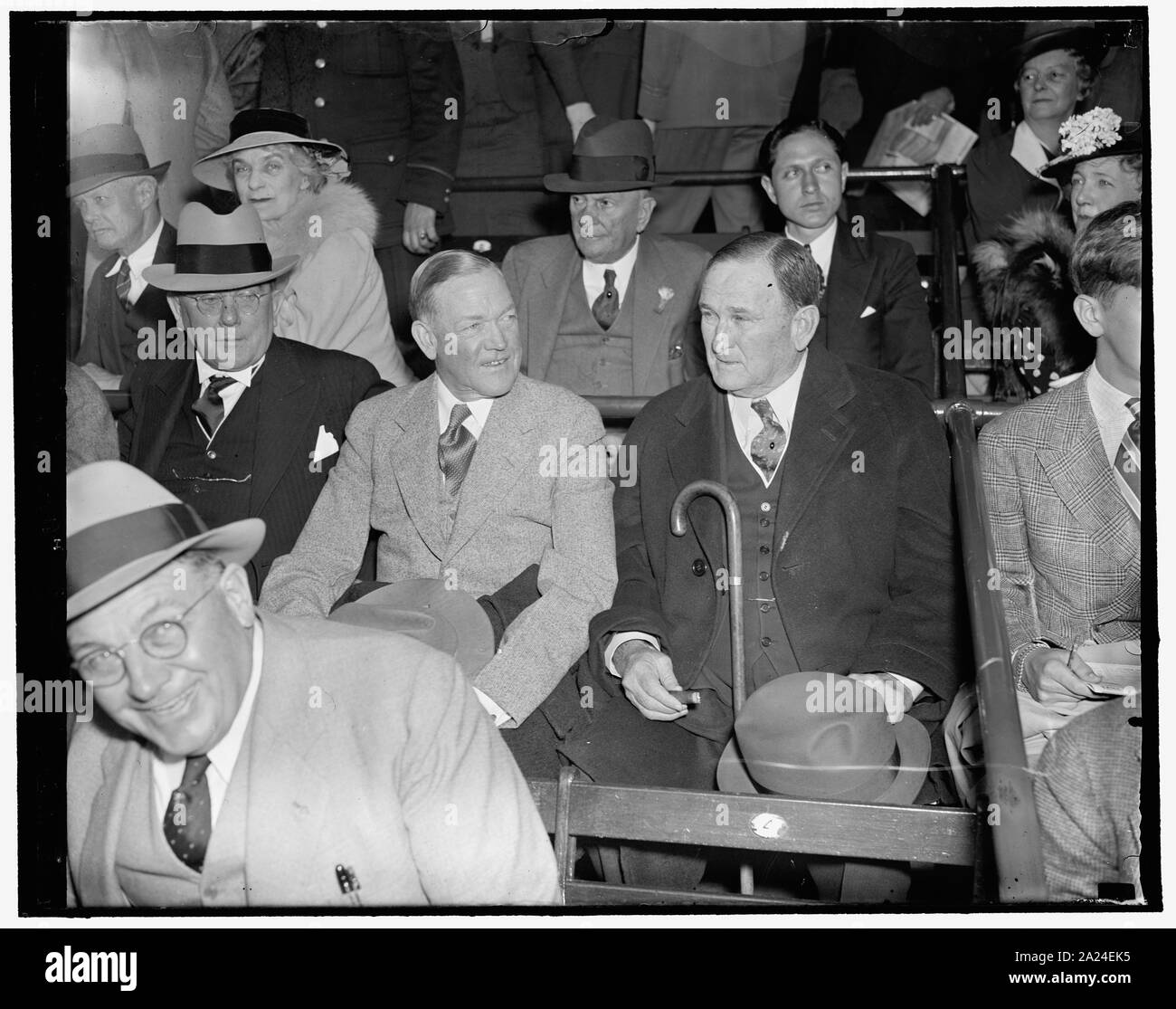 Party Leaders enjoy opening game. Washington, D.C., April 19. Party ties were forgotten today as Democratic and Republican members of Congress attended the opening game of the 1937 baseball season in Washington between the Senators and Philadelphia Athletics. Here we see, Republican Majority Leader of the Senate Charles L. McNary, of Oregon; and Senator Joseph T. Robinson, Democratic Majority Leader, viewing the game from a field box, 4/19/1937 Stock Photo
