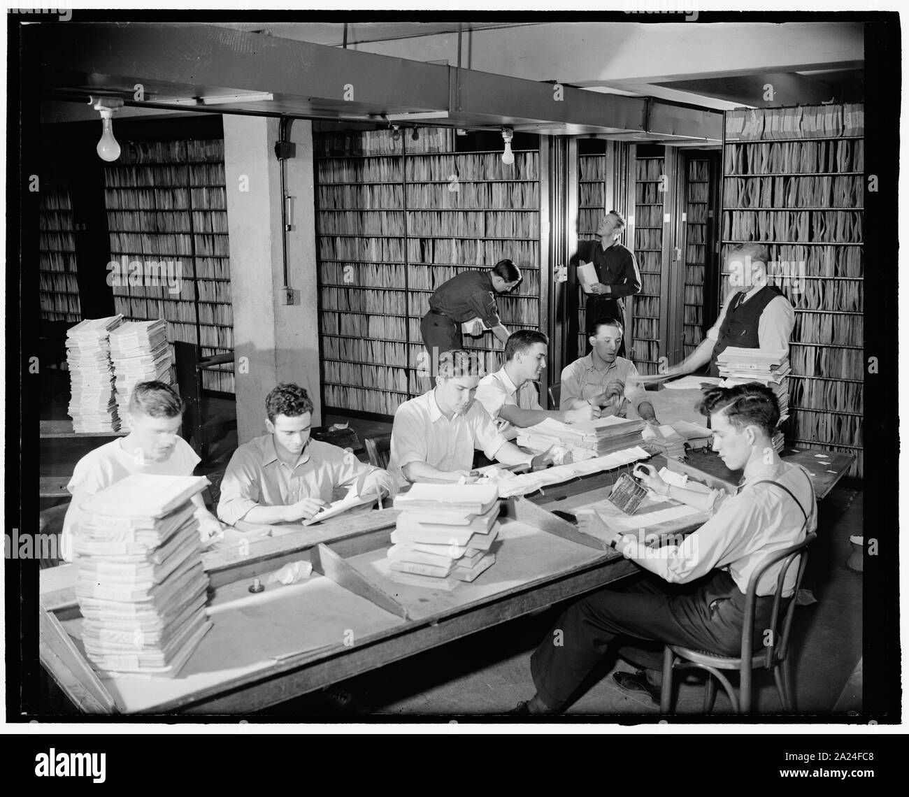 Patent Office files. Washington, D.C., Feb. 29. Employees in the patent office file room. Approximately 2,180,00 patents are kept on file for public use, 2-29-40 Stock Photo