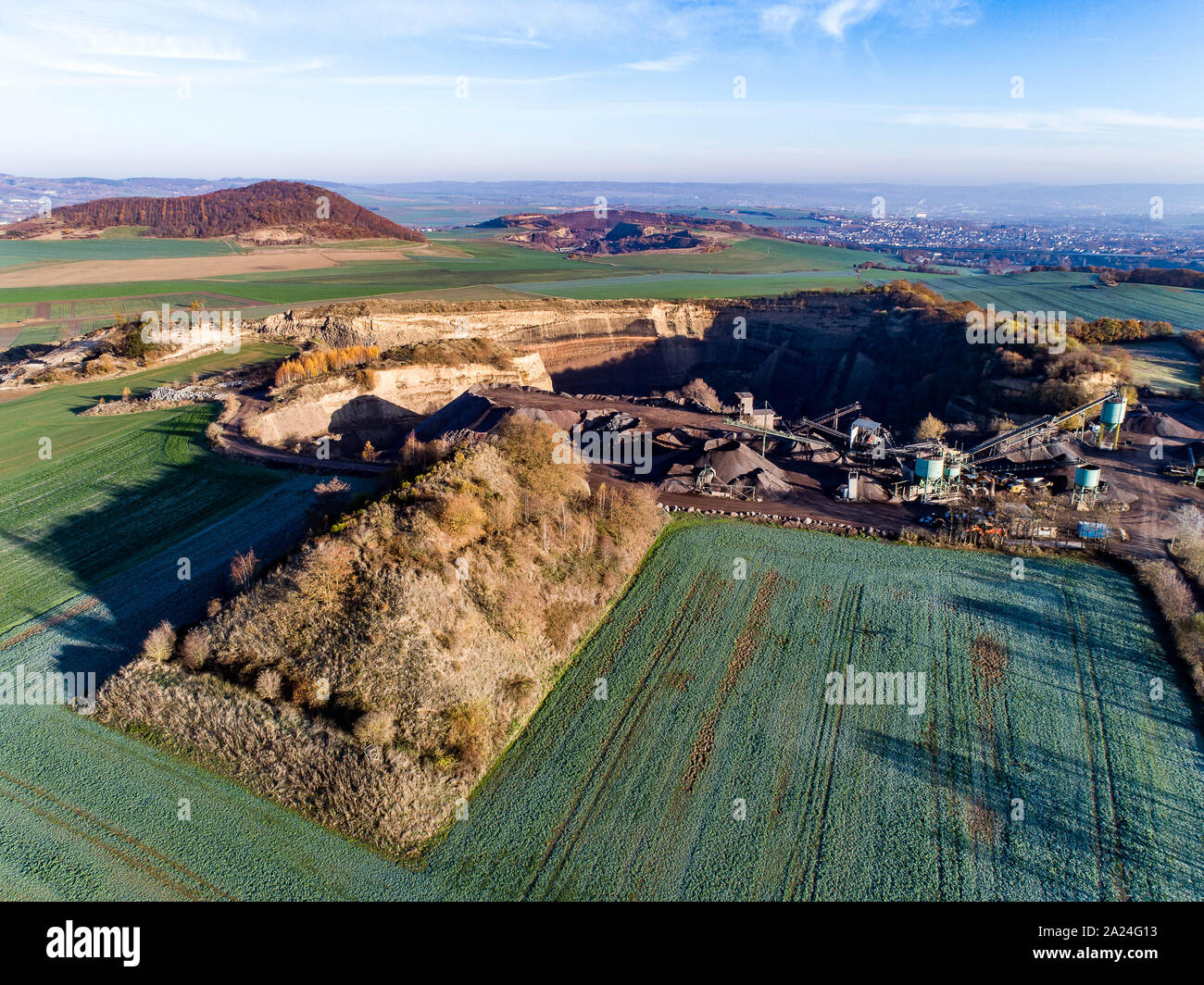 Aerial view of machinery in open gravel pit mining. Processing plant for crushed stone and gravel. Mining equipment. Stock Photo