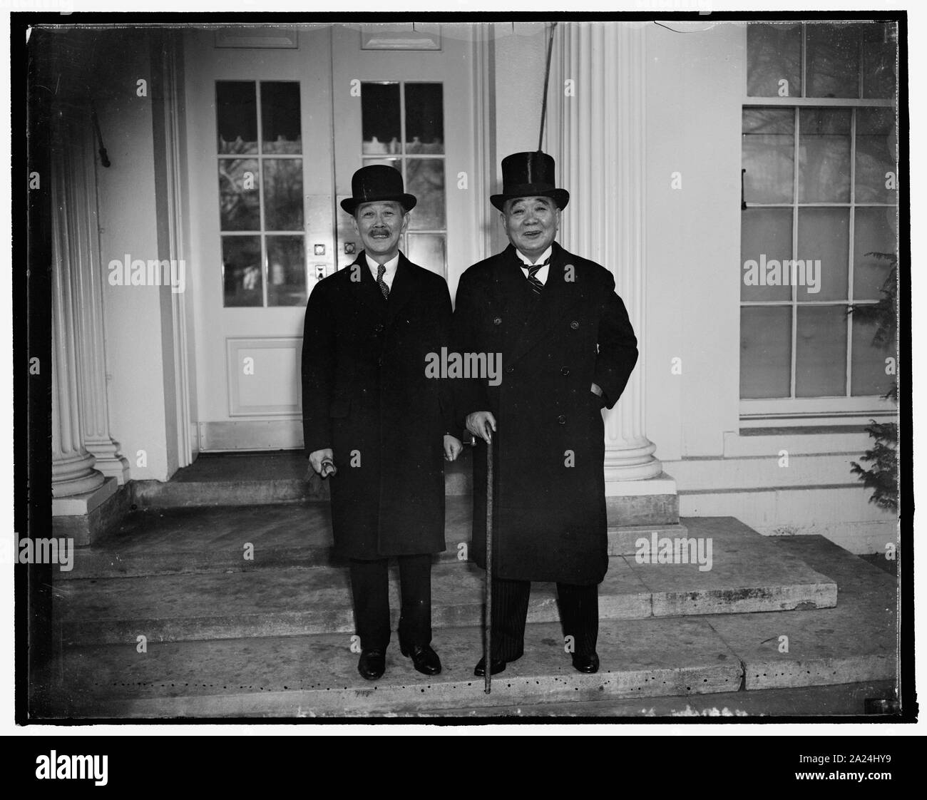 Pay respects to the president. Washington, D.C., Dec. 10. Othoiko Matsukata, left, classmate of President Roosevelt while at Harvard introduces his brother, Kojiro Matsukata, a Former Yale man to the President today. They are shown after leaving the White House after paying respects Stock Photo